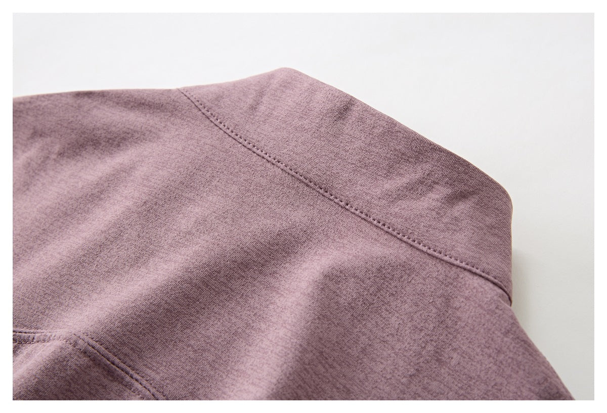 Close-up of a stitched panel seam on mauve heather fabric.