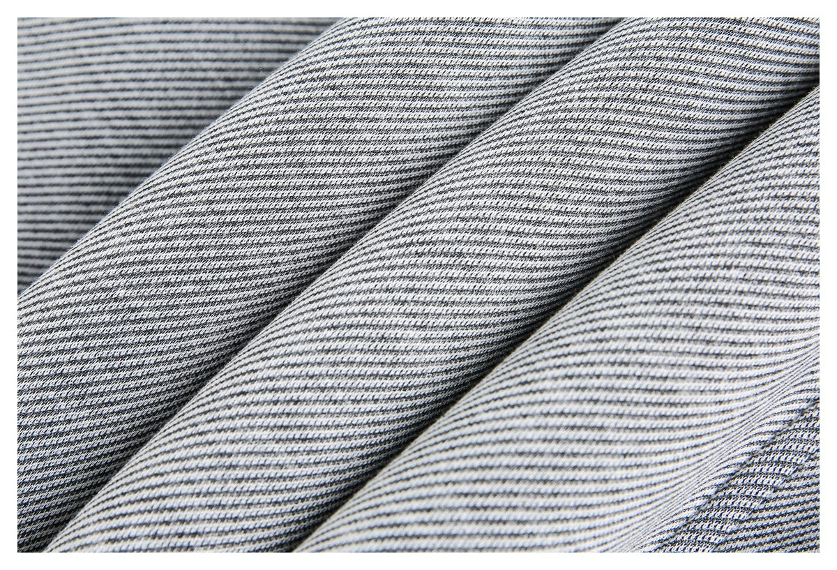 Close-up of gray and white finely striped jacket fabric draped in folds.