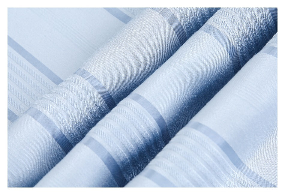 Close-up of folded light blue fabric showing alternating stripe textures.