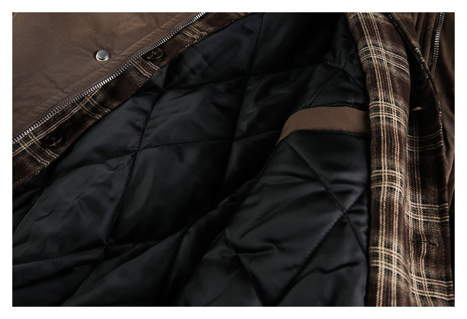 Open brown jacket showing black diamond-quilted lining and brown plaid trim.
