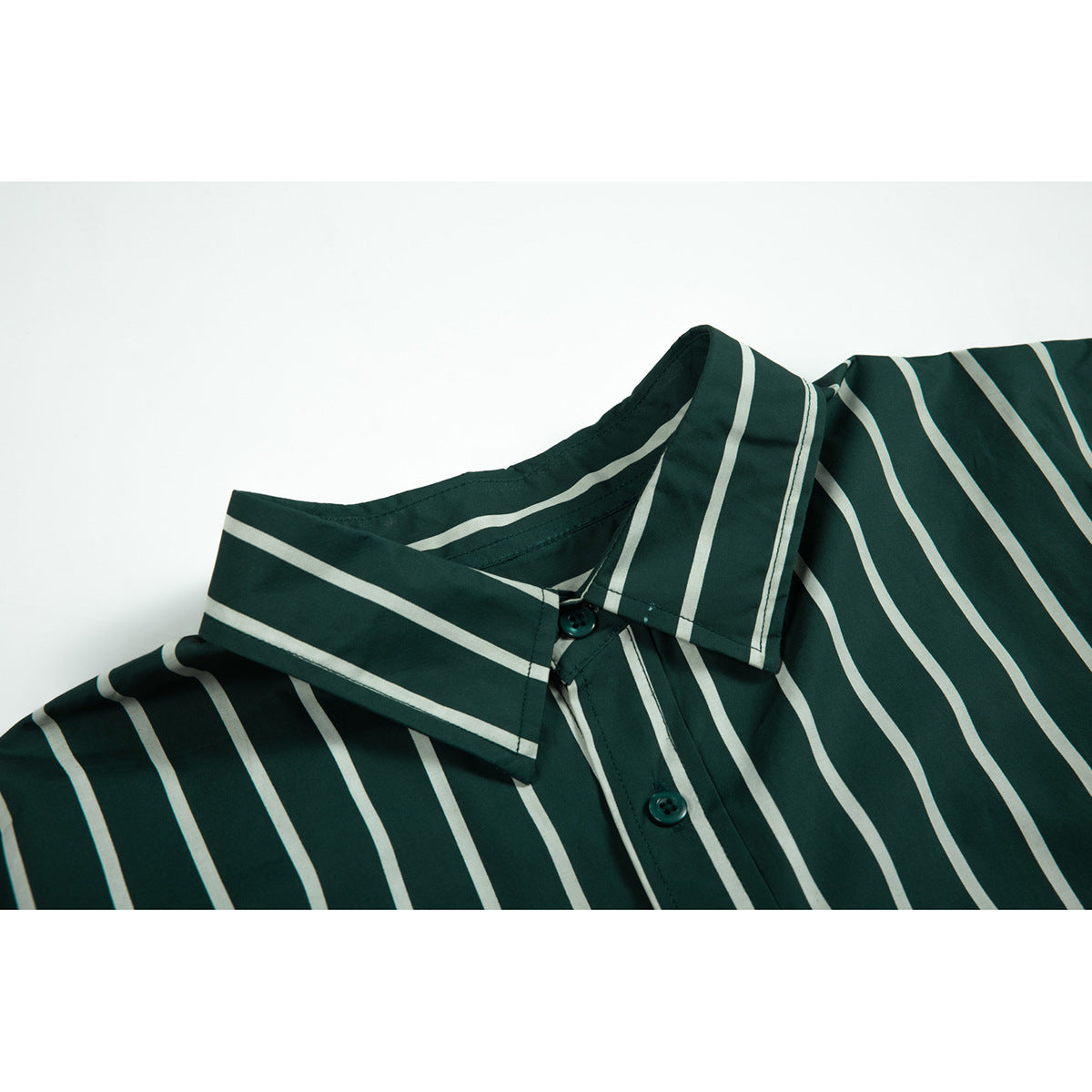 Close-up of a dark green shirt collar and button placket with thin cream stripes.