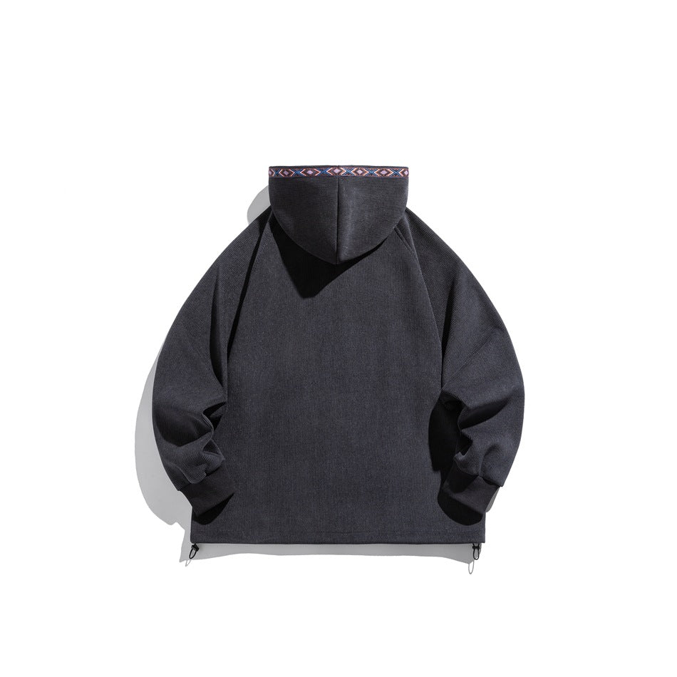 Back view of gray ribbed hoodie with woven geometric trim along the hood edge and hem drawcord toggles