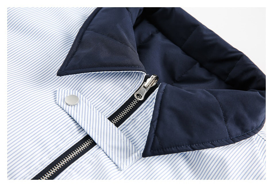 Close-up of a navy padded collar, striped lining, snap tab, and zipper.