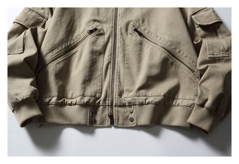 Cropped front view of a taupe zip jacket with diagonal zip pockets, snap buttons, ribbed hem and cuffs.