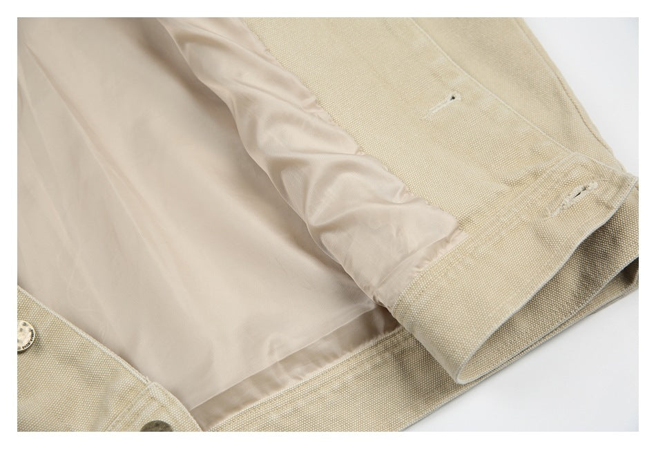 Beige jacket shown open to reveal its smooth pale lining and inside seams.