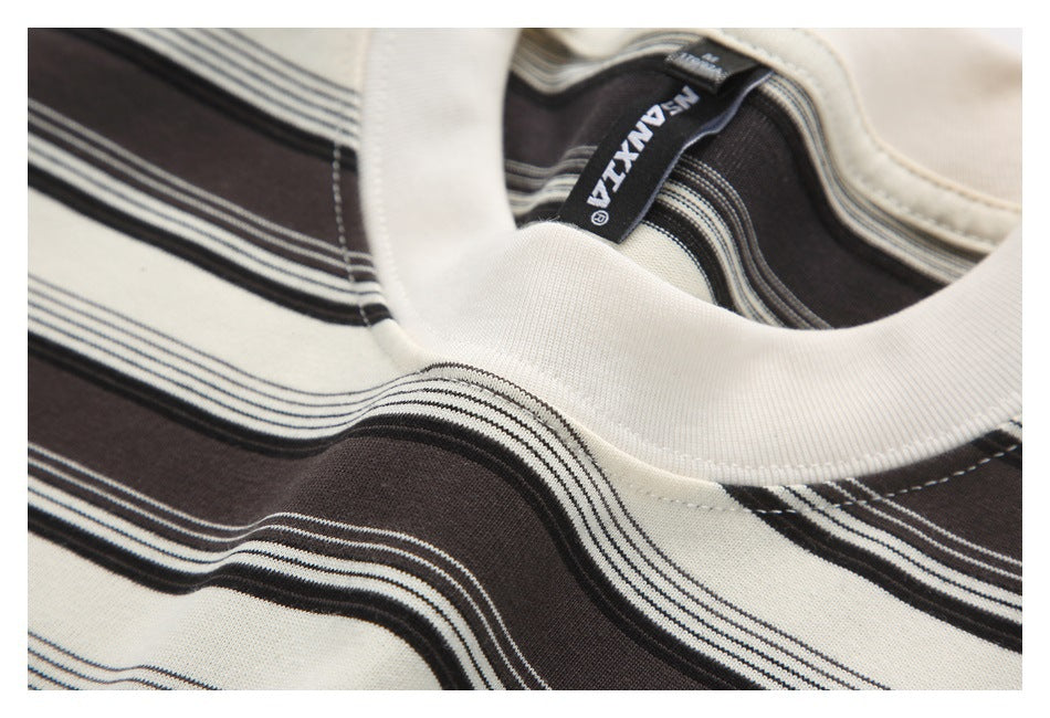 Close-up of the cream ribbed crew neckline and striped fabric, with a black inner neck label.