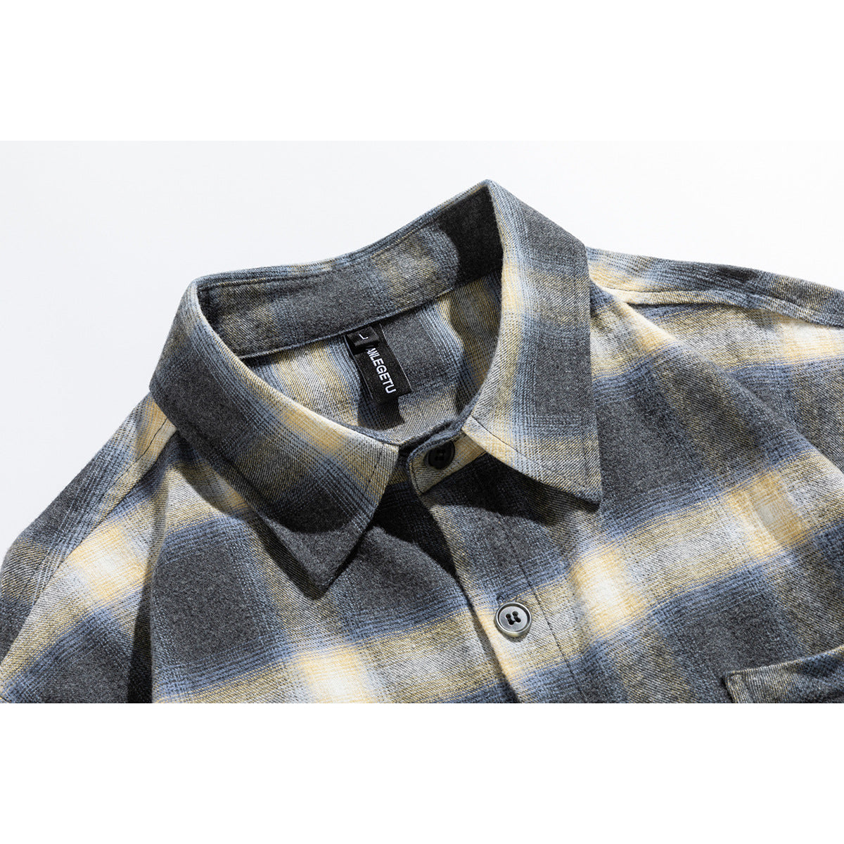 Close-up of a gray, blue, and cream plaid shirt collar, buttons, and sewn neck label.