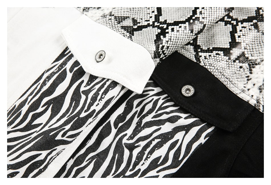 Close-up of white and black jacket cuffs with zebra stripes, snakeskin-print panels, and metal snaps.
