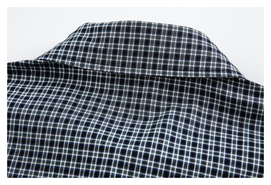 Close-up of the back collar and yoke of a black, white, and blue checked shirt.