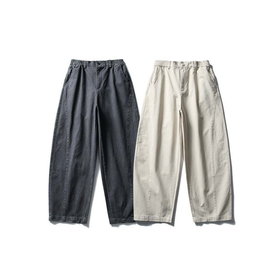 Front view of two pairs of wide-leg pants, one charcoal gray and one light beige, displayed side by side.