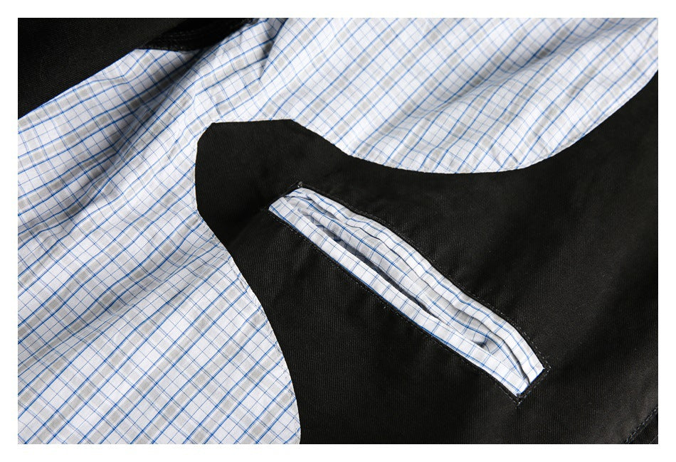 Close-up of a pocket opening on black fabric, trimmed with white and blue checked lining.