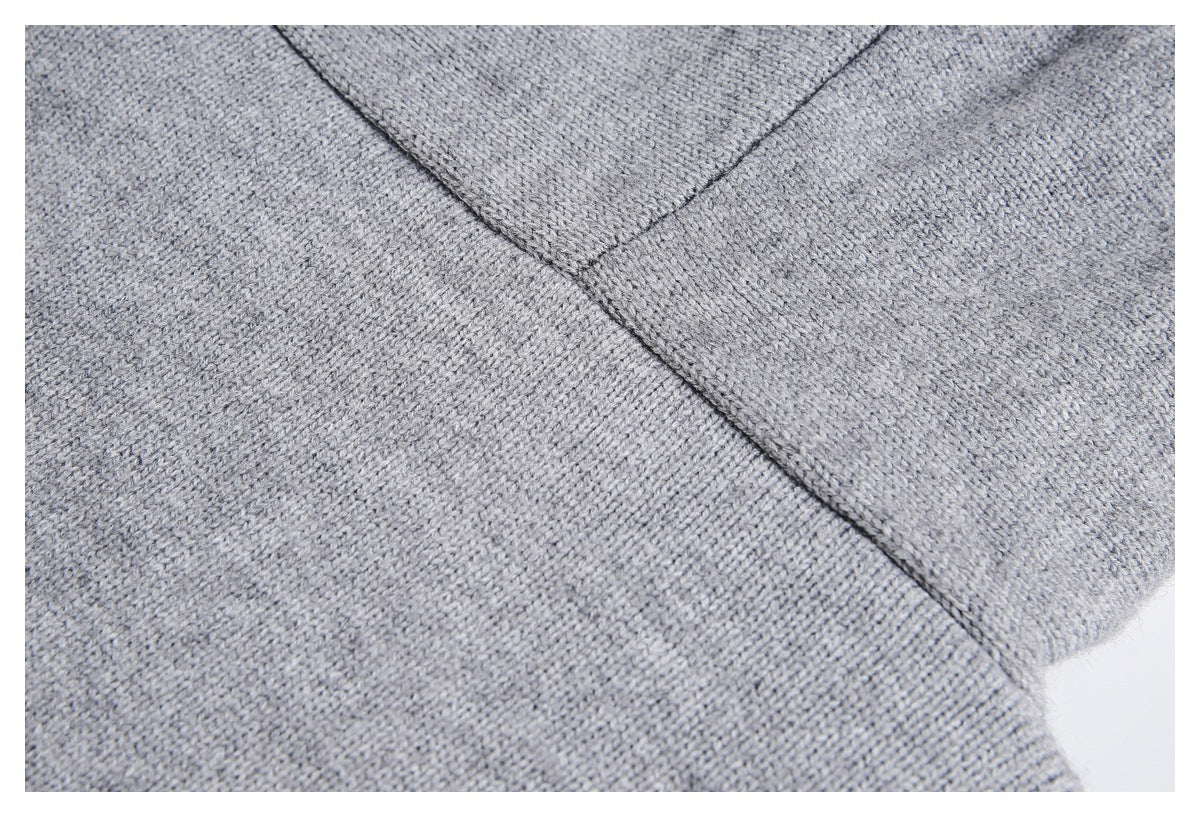 Close-up of the gray knit jacket's fabric and a stitched seam.