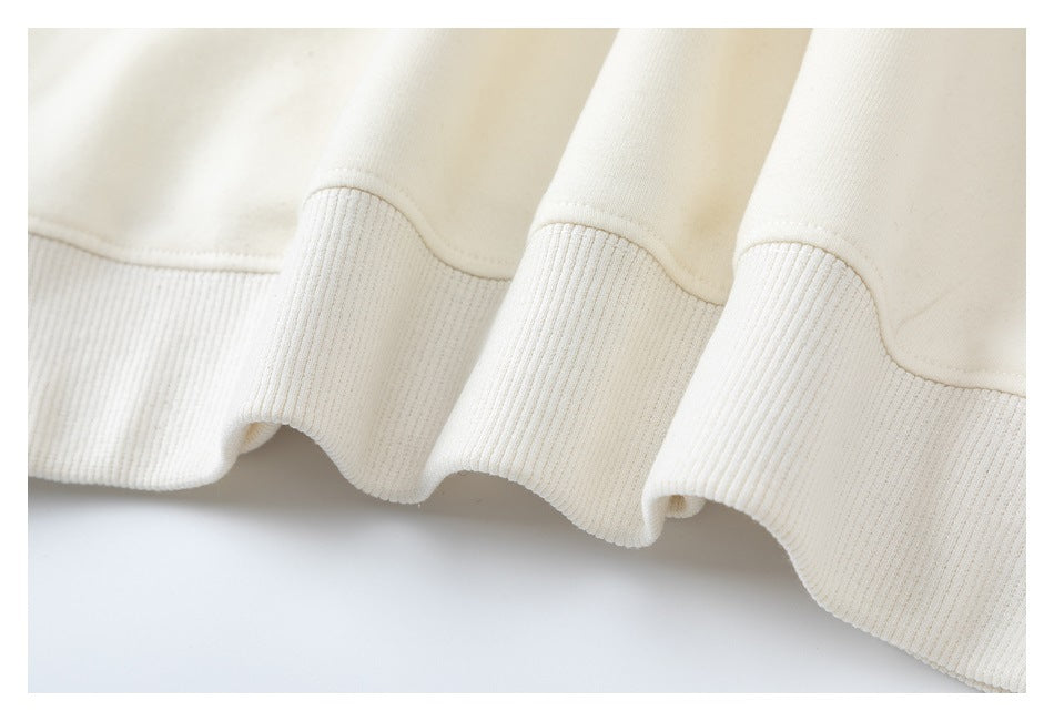 Close-up of an ivory garment's wide ribbed hem.
