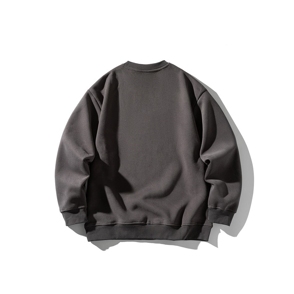 Back view of a plain charcoal gray crewneck sweatshirt laid flat against a white background.