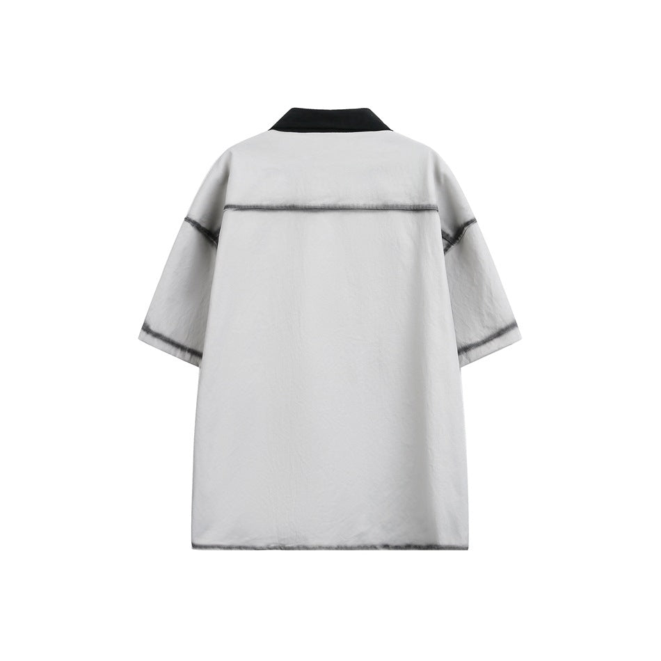 Back view of a light gray short-sleeve shirt with a black collar and dark contrast seams.