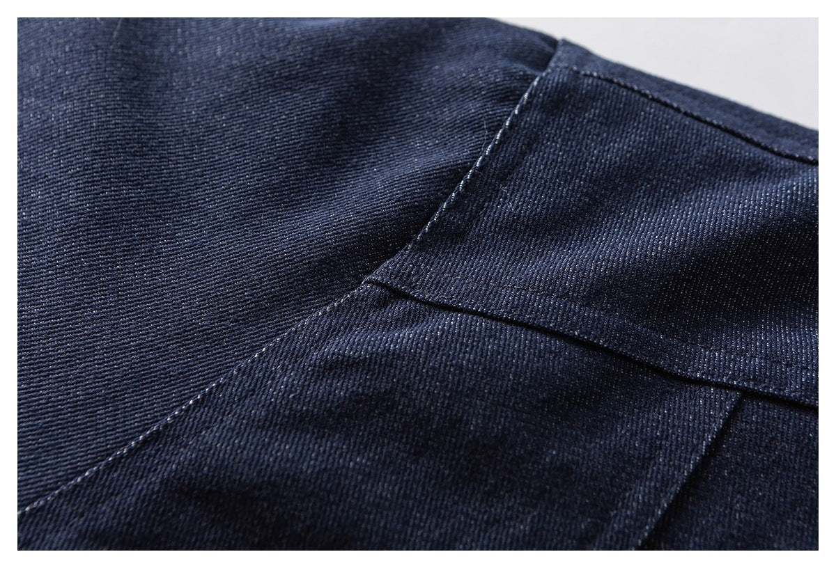 Close-up of stitched seams on dark navy twill fabric.