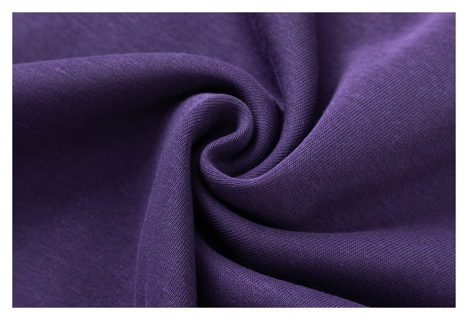 Macro view of the purple sweatshirt fabric gathered into soft folds.