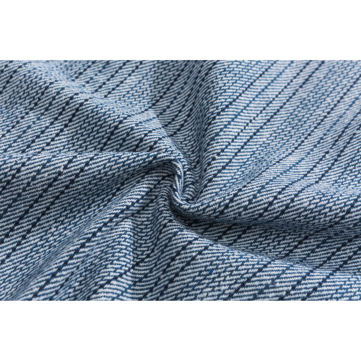 Close-up of blue-and-white striped shirt fabric gathered into folds.