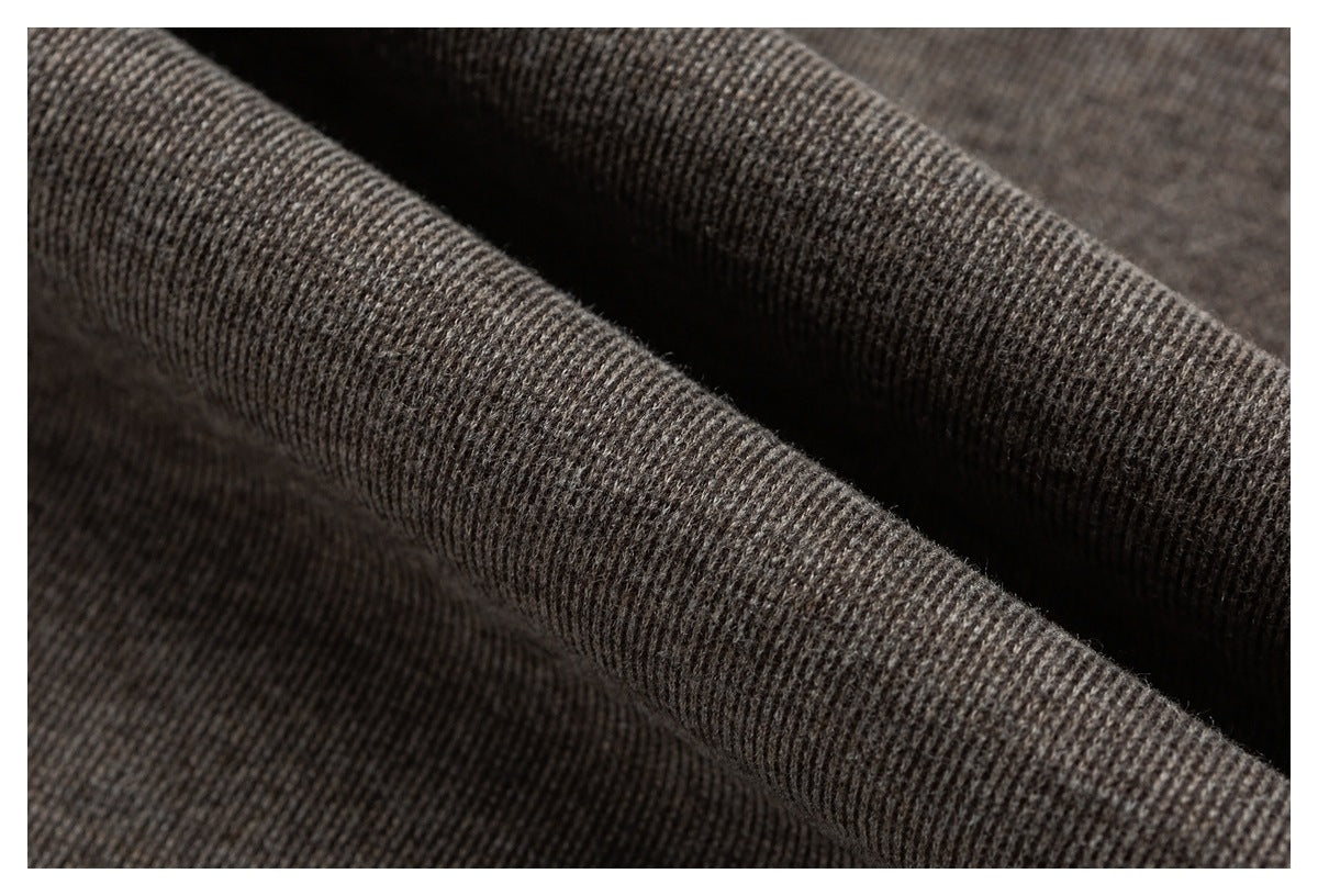 Macro view of the brown knit fabric folded to show its textured surface.