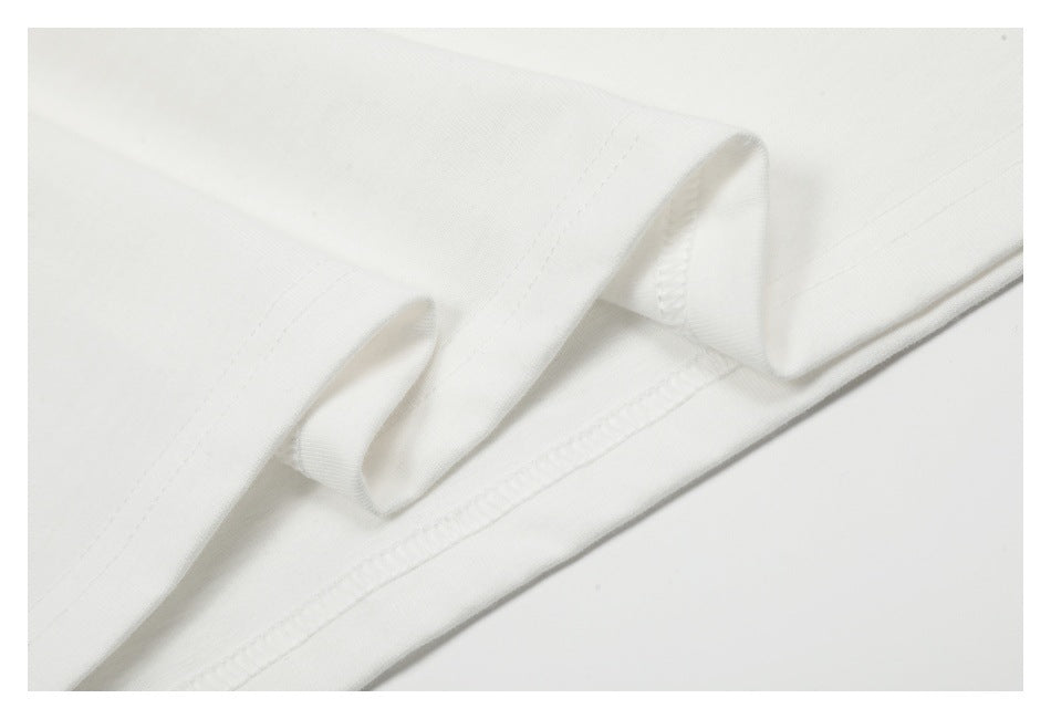 Close-up of folded white fabric showing a stitched edge and seam.