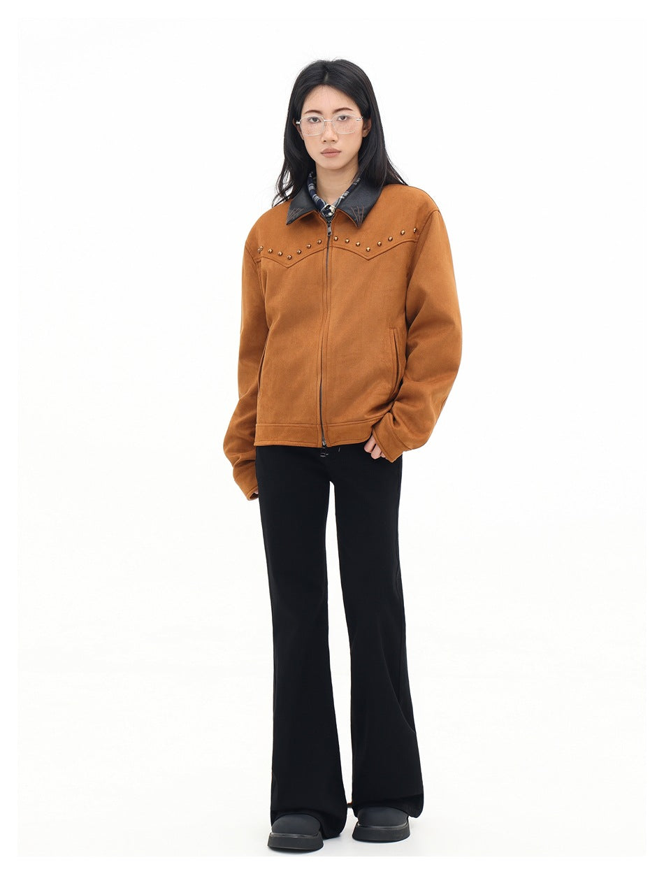 Front view of a model wearing a rust-brown zip jacket with a black collar and gold stud detailing.