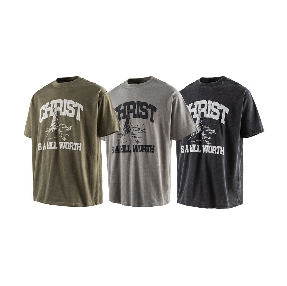 Three short-sleeve graphic T-shirts in olive, gray, and black, each with a large contrasting front print.