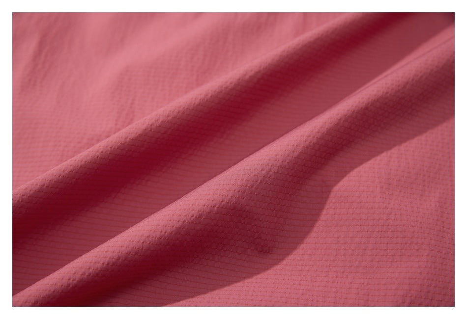 Close-up showing the fine grid texture and folds of dusty rose fabric.