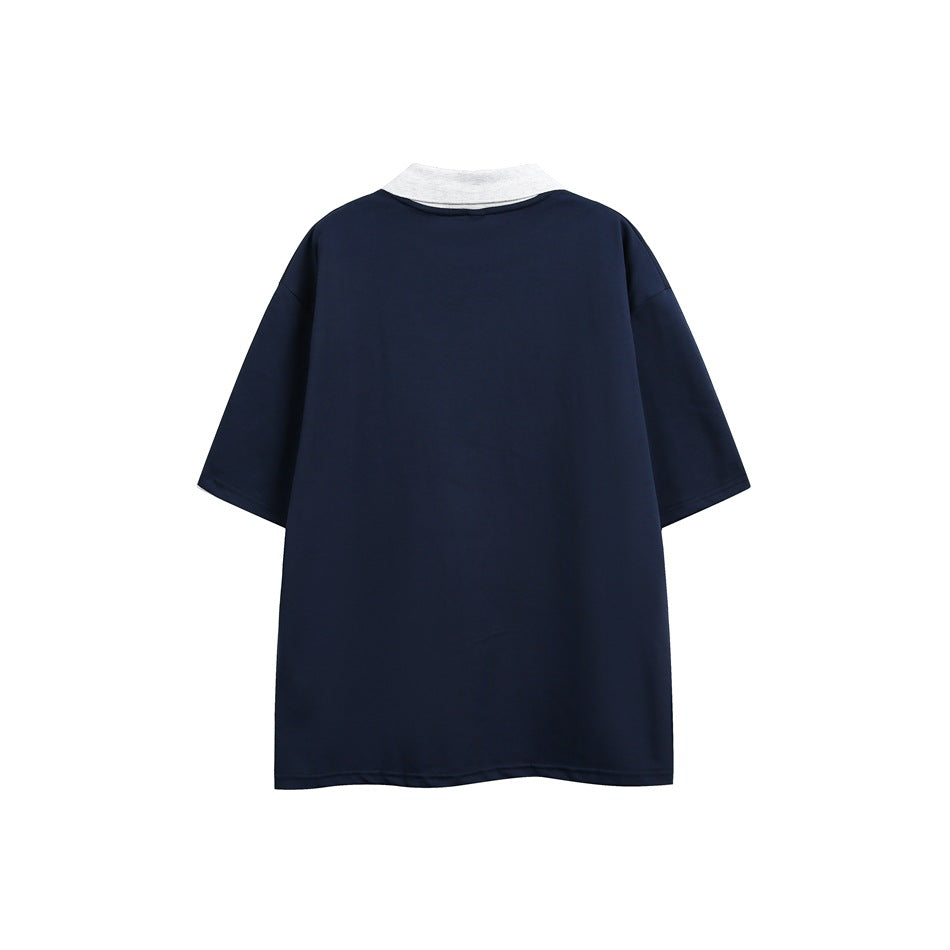 Back view of a loose navy short-sleeve polo shirt with a contrasting light gray collar.