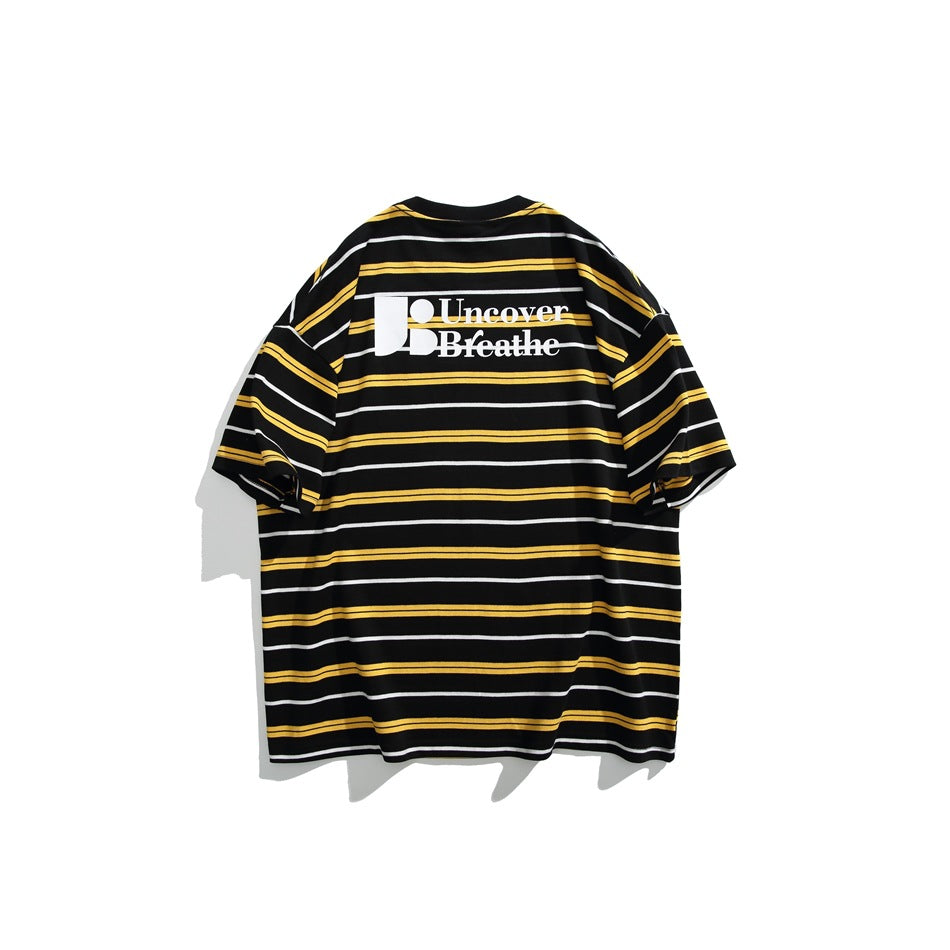 Back of a black T-shirt with yellow and white horizontal stripes and a large white graphic print.