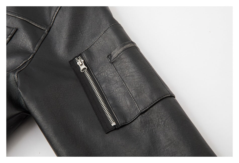 Close-up of a black jacket sleeve pocket with a metal zipper and stitched panel seams.