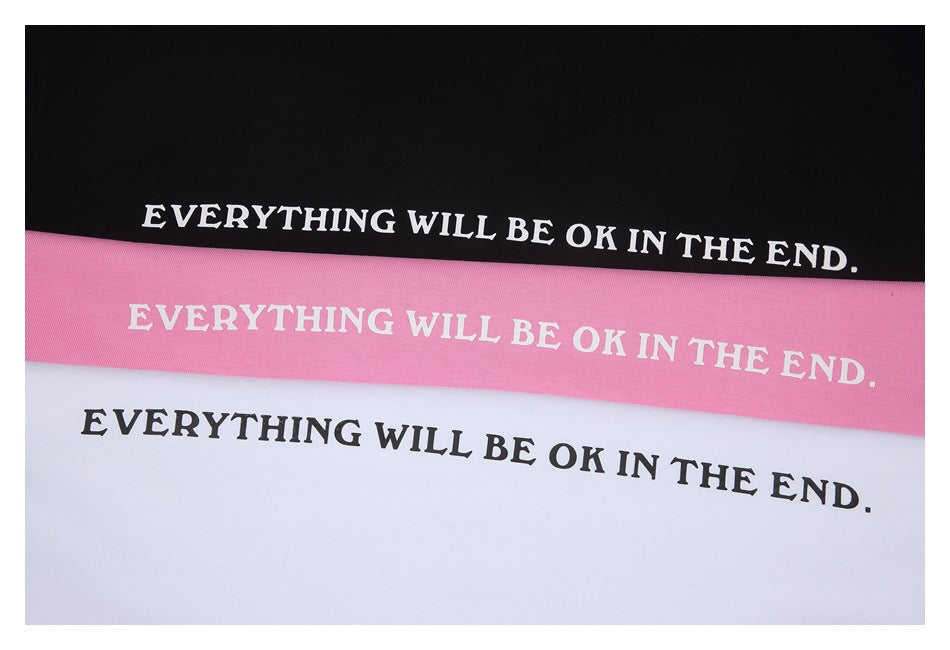 Black, pink, and white fabric panels display the phrase “EVERYTHING WILL BE OK IN THE END.”