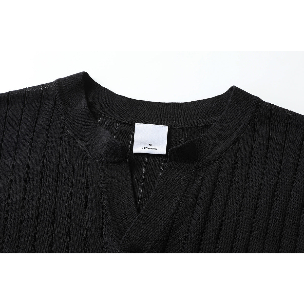Close-up of a black ribbed short-sleeve top showing its split neckline, collar, and size label.