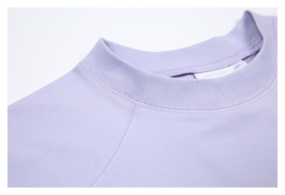 Close-up of the lavender shirt's ribbed crew neckline and stitched shoulder seam.