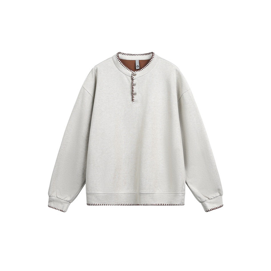 Light beige-gray Henley sweatshirt with brown whipstitch trim and brown inner neck facing, flat lay