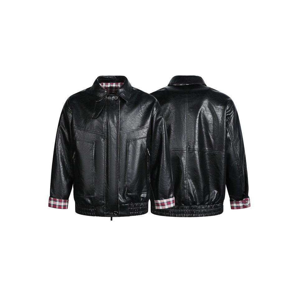 Black jacket shown from front and back, with plaid collar lining and cuffs, chest seams and gathered hem.