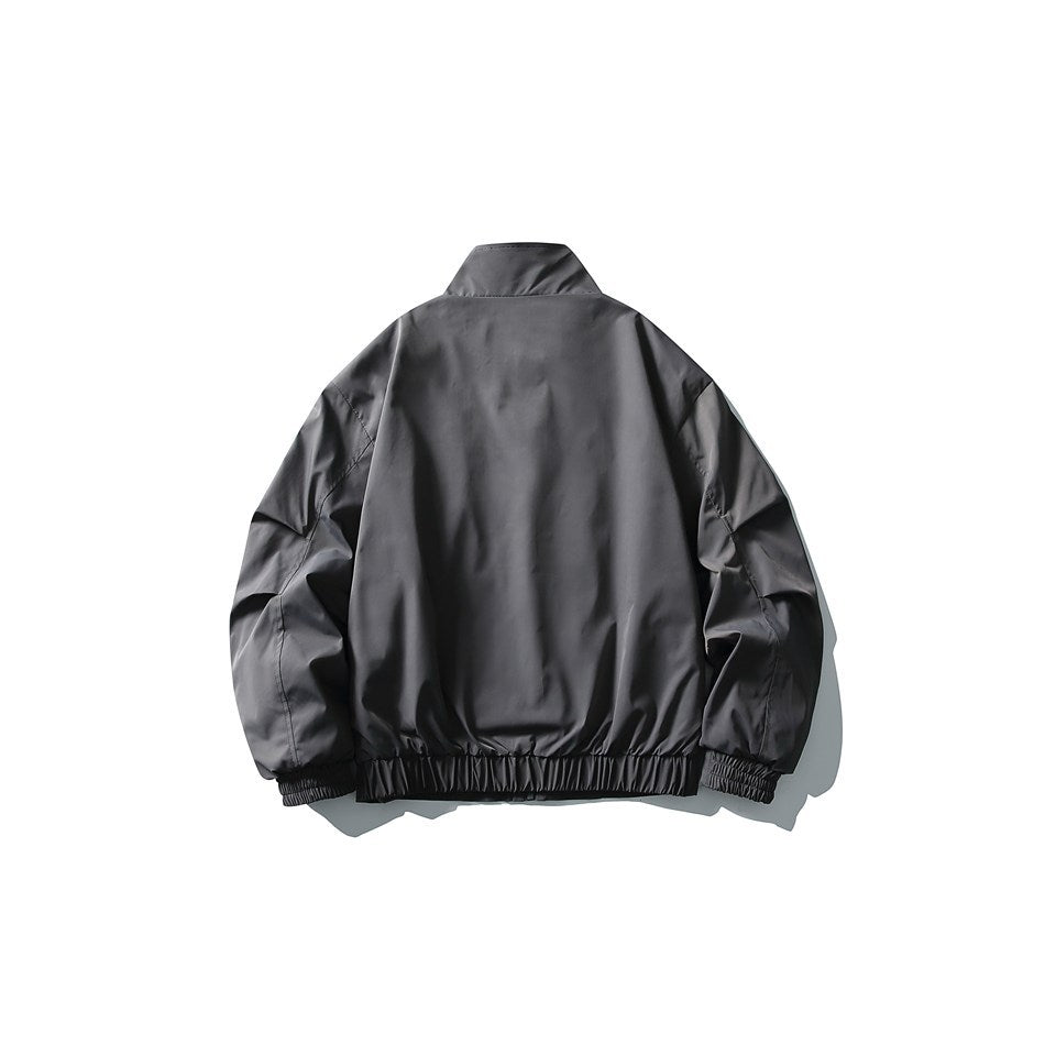Back view of a charcoal stand-collar jacket with gathered cuffs and an elasticated hem.