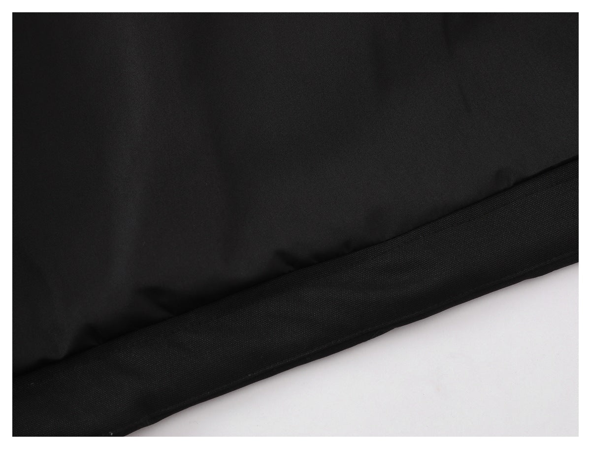 Close-up of the black garment's stitched lower hem.