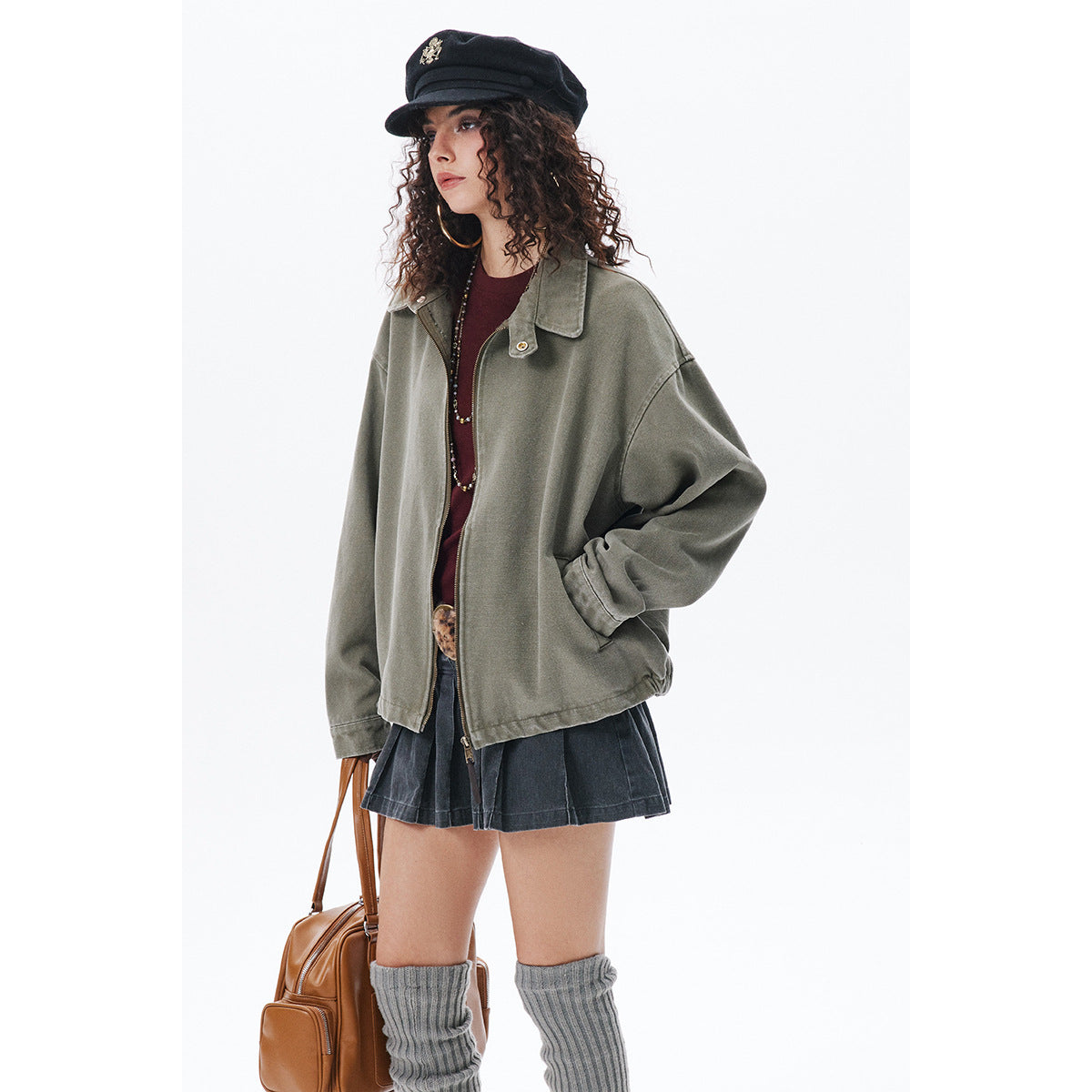 Model wearing an oversized olive-gray zip-front jacket with a wide collar and front pockets.