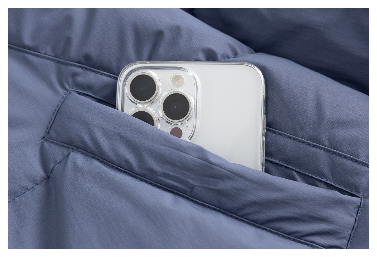 Close-up of a blue-gray jacket pocket holding a smartphone.