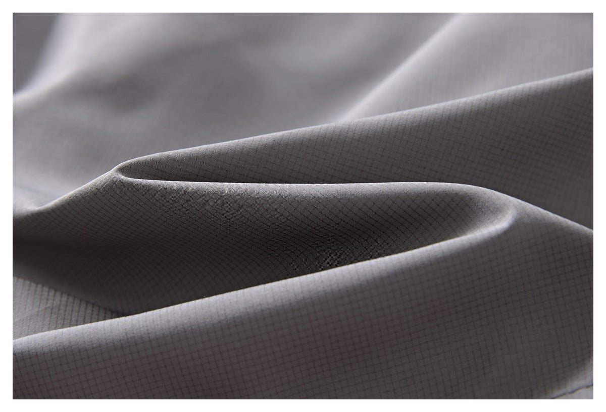 Close-up showing the fine, subtle grid pattern on folded gray fabric.