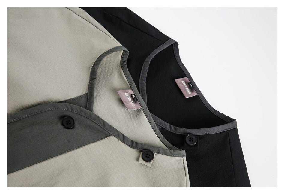 Close-up of beige and black shirts showing contrasting dark trim, buttons, and neckline labels.