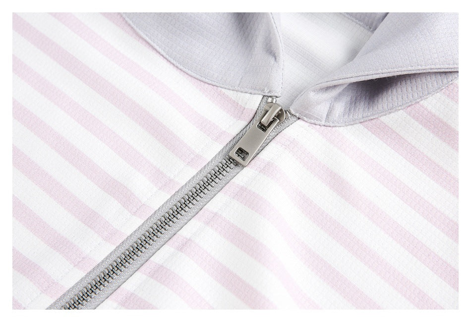 Close-up of the metal zipper and light gray collar on a pale pink and white striped garment.