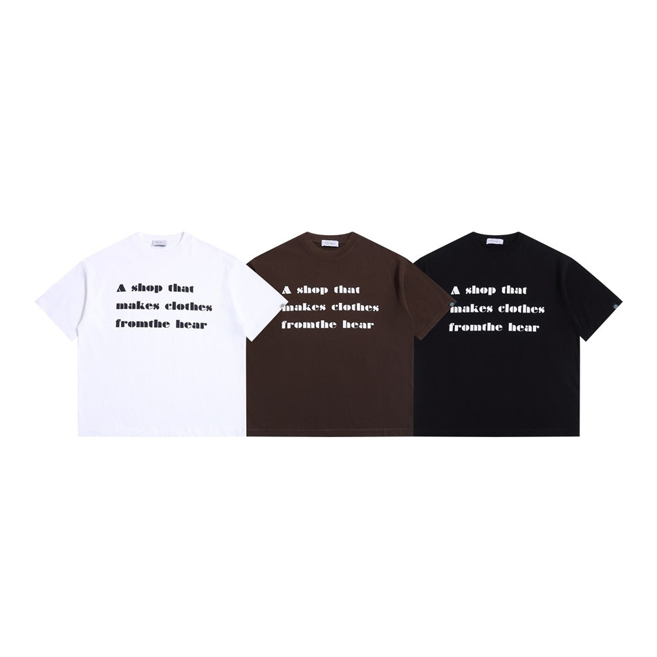 Three short-sleeve crew-neck T-shirts in white, dark brown, and black, each with the same white front text graphic.