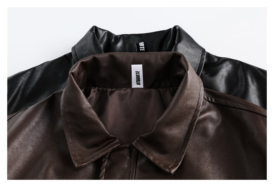 Close-up of the collars and inner labels of black and dark brown jackets.
