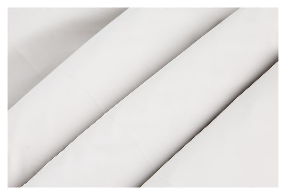 Close-up of smooth pale gray fabric arranged in overlapping folds.