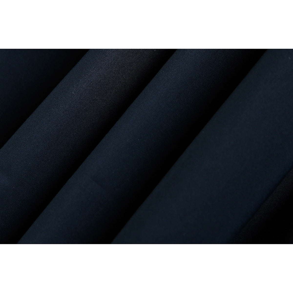 Macro view of the smooth dark navy fabric in soft folds.