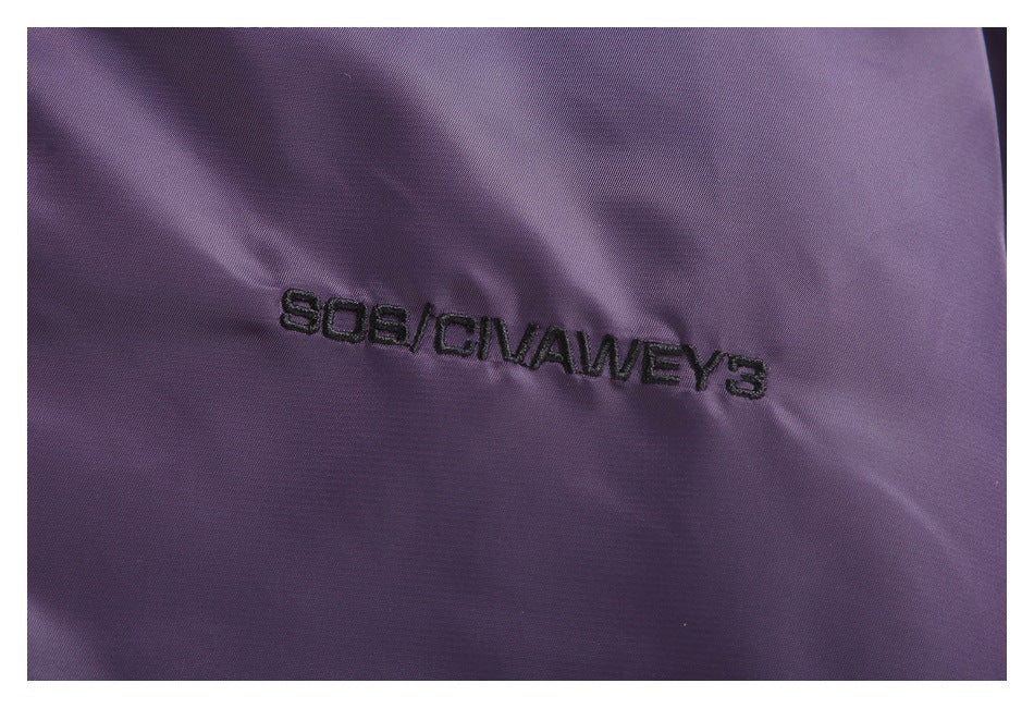 Close-up of black embroidered lettering on the purple jacket fabric.