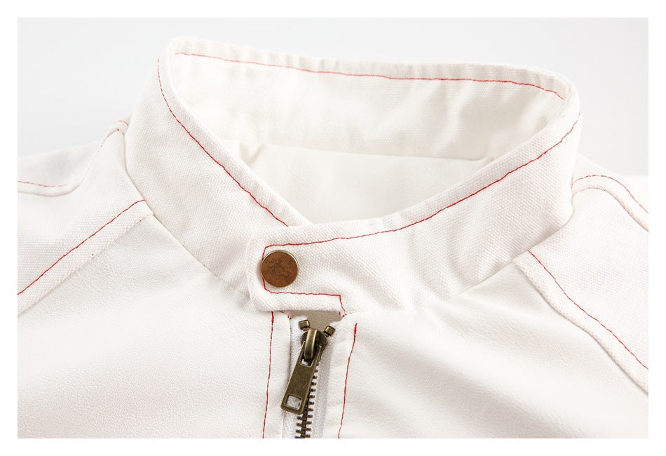 Close-up of the white jacket's stand collar, brass snap, front zipper, and red stitching.