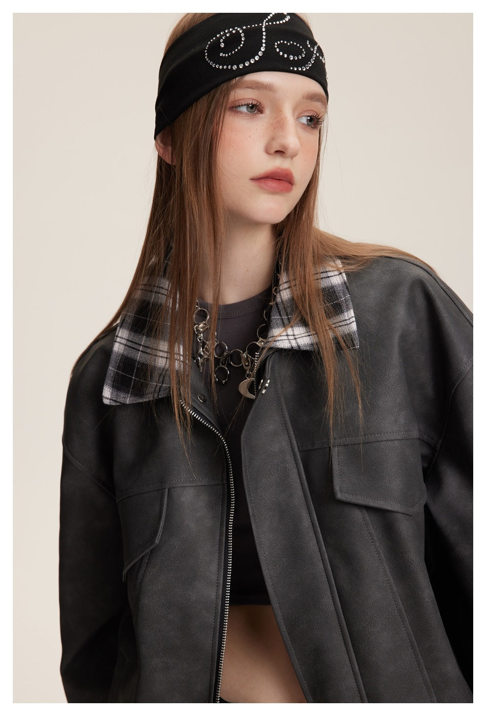 Model wearing a charcoal jacket with a black-and-white plaid collar, zipper and flap chest pockets.