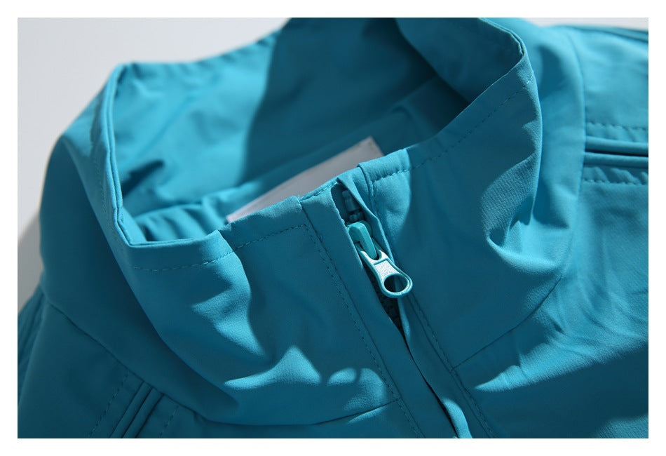 Close-up of the turquoise jacket’s raised collar and matching zipper pull.